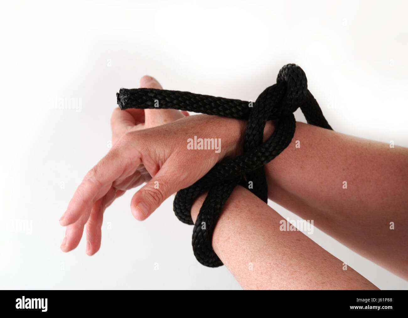 bound tied tie rope hand hands conflict frustration crisis depression cord Stock Photo