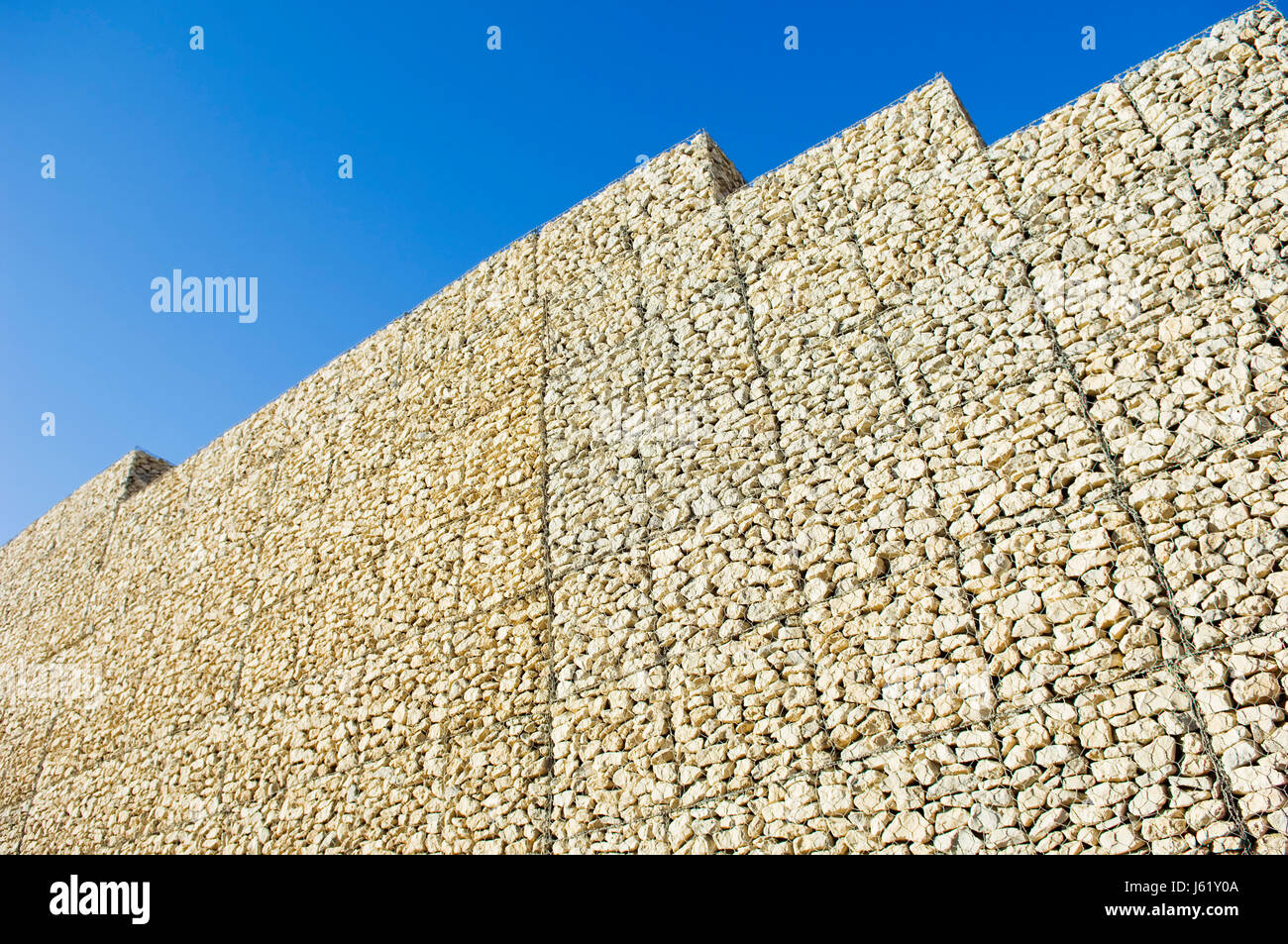 stone barrier stack box mesh boulder block backdrop background blue Stock  Photo - Alamy