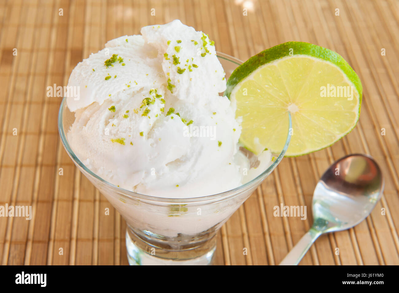 Healthy coconut lime dairy-free ice cream on a bamboo mat Stock Photo