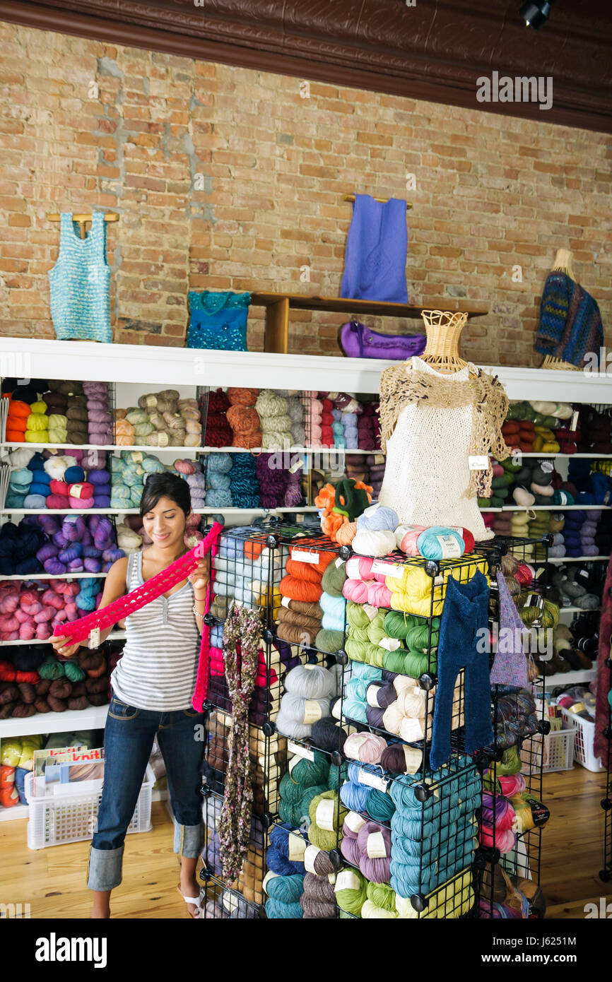 Valparaiso Indiana,Sheep's Clothing,knitting supplies,yarn,wool,multi color,craft,hobby,display sale Hispanic ethnic woman female women,shelf shelves, Stock Photo