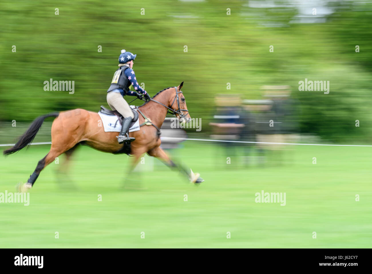 Rockingham Castle grounds, Corby, UK. 19th May, 2017. The horse 'Avocado' ridden by Scarlett Wills hurtles past spectators during the cross country event in the grounds of the Norman Rockingham Castle, Corby, England, on Thursday 19th May 2017. Credit: miscellany/Alamy Live News  Stock Photo