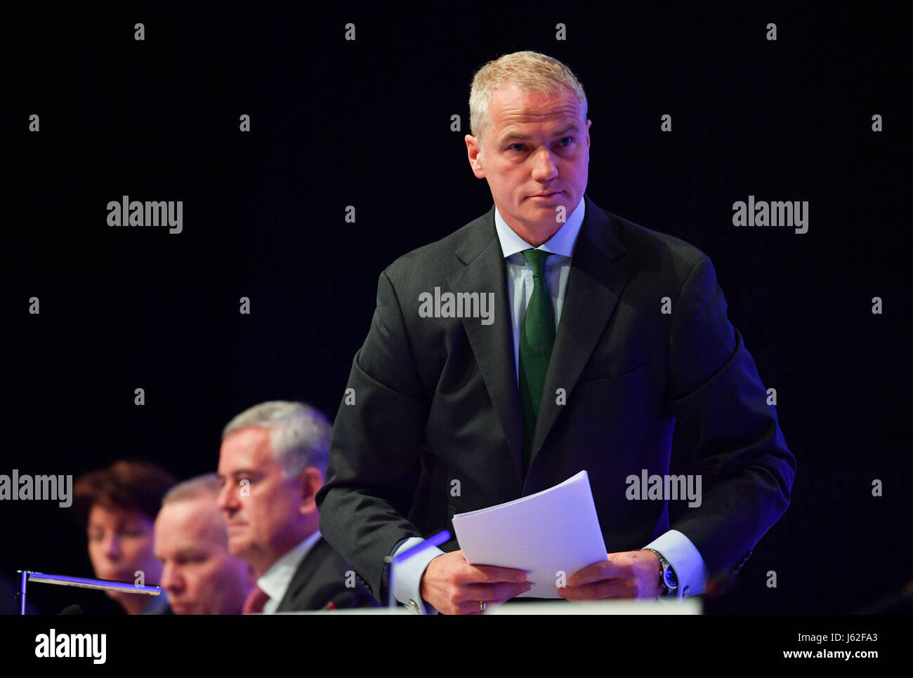 Carsten Kengeter (r), chairman of the Deutsche Boerse AG (lit. 'German stockmarket'), stands up next to board members Hauke Stars (l-r), Andreas Preuss and Gregor Pottmeyer during the general assembly of the company at the 'Jahrhunderthalle' in Frankfurt/Main, Germany, 17 May 2017. Photo: Arne Dedert/dpa Stock Photo