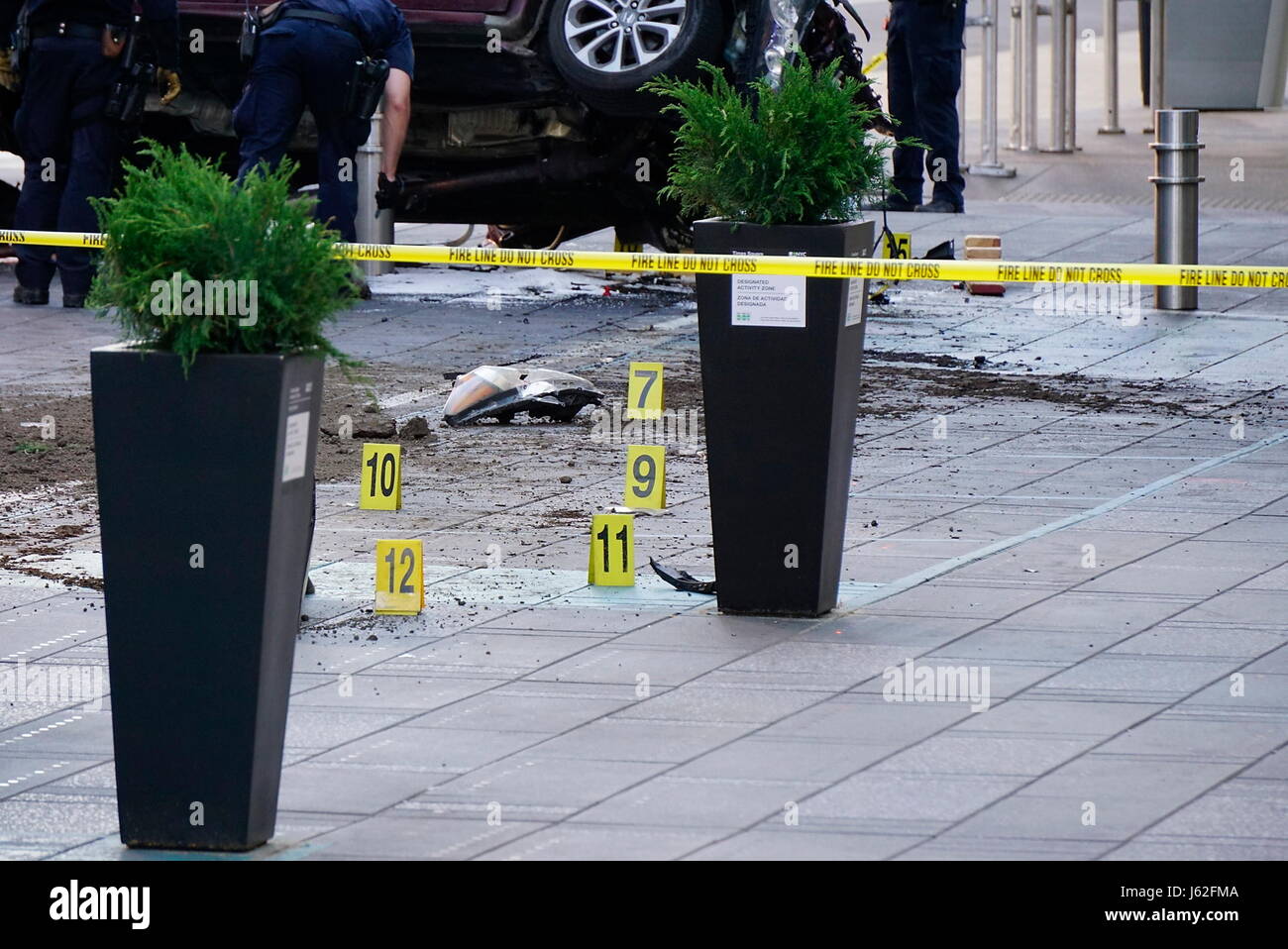 New York, New York, USA. 18th May, 2017. Crime scene markers near the damaged vehicle as Police officers investigate the scene of a car crash in Times Square that took the life of an 18 year-old Michigan girl and injured 22 others Credit: Kevin C. Downs/ZUMA Wire/ZUMAPRESS.com/Alamy Live News Stock Photo