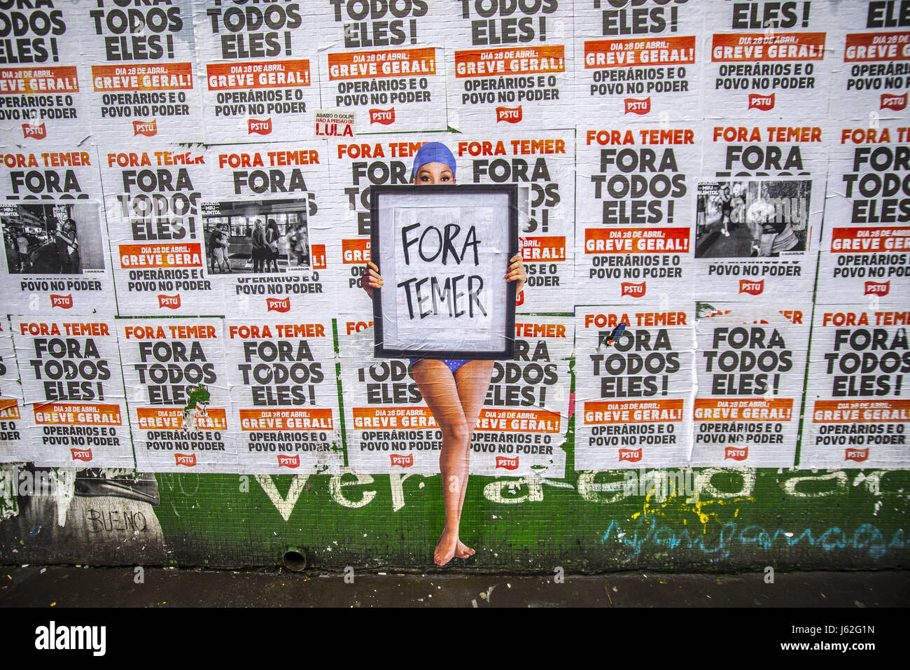 May 19, 2017 - SÃ¢O Paulo, SÃ£o paulo, Brazil - SAO PAULO, BRAZIL - MAY 19: A wheat-paste piece of street art by artist Luis Bueno depicting a bather holding a poster that says ''Outside Temer'' at Paulista Avenue on May 19, 2017 in Sao Paulo, Brazil. In the face of the crisis generated by the recording of his talks with businessman Joesley Batista of the JBS refrigerator and the opening of an inquiry into his name on the Supreme Court, President Michel Temer (PMDB) said he would not resign. ''I will not resign, '' he said. ''I know what I did and I know the correctness of my actions, '' he sa Stock Photo