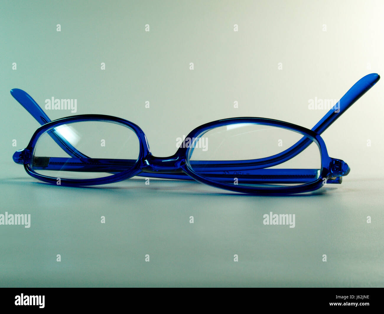 spectacles glasses eyeglasses reading glasses spectacled blue macro close-up Stock Photo