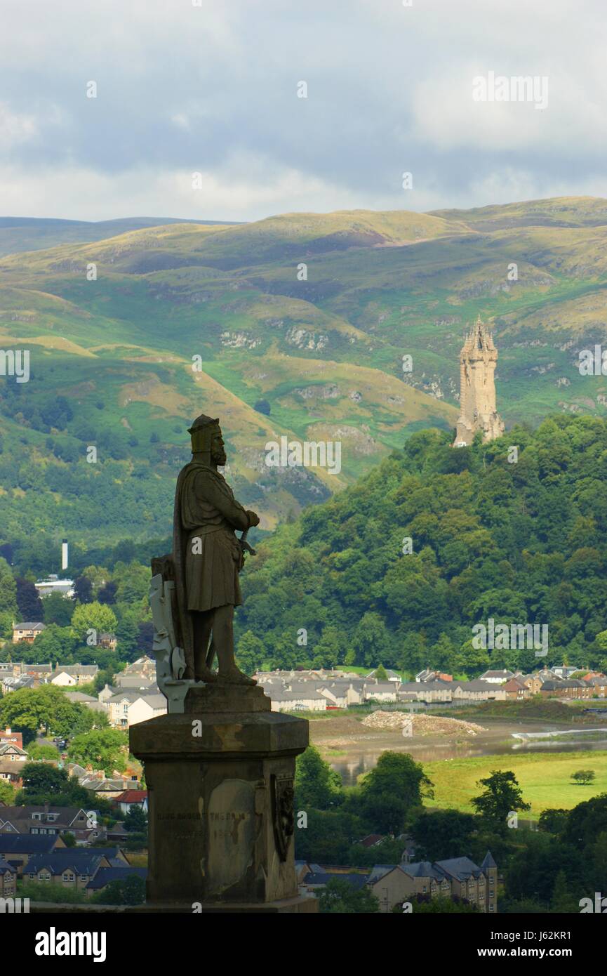 tower statue valley scotland emperor king tower historical houses city town Stock Photo