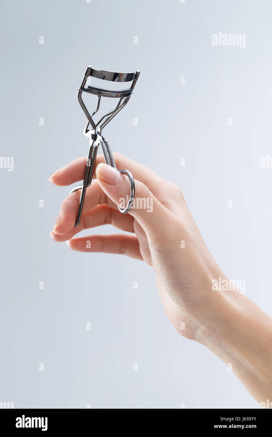 The hand holding the eyelash curler Stock Photo Alamy