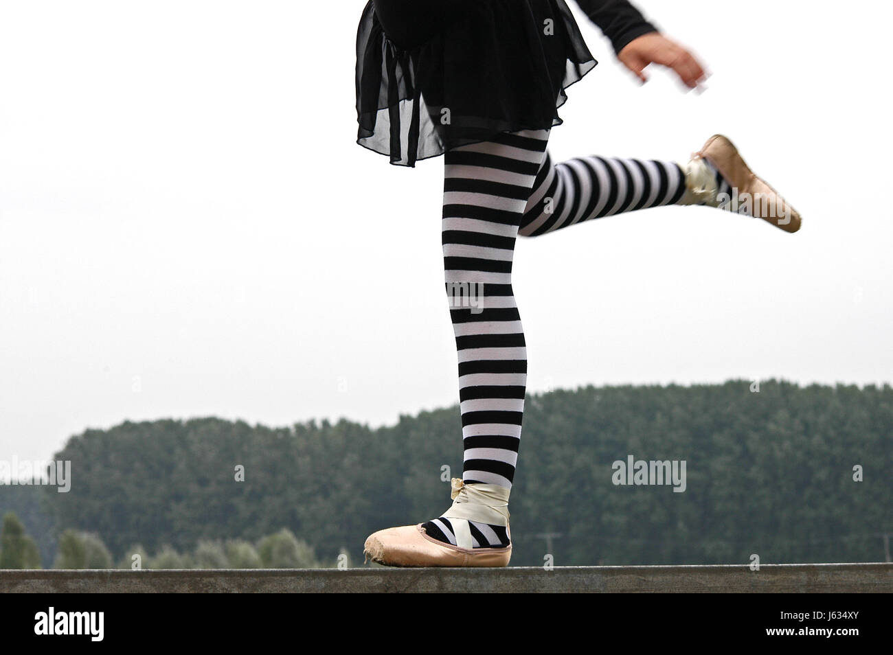 balance bar level-crossing one-legged cupboards ballerina stand legs motion Stock Photo