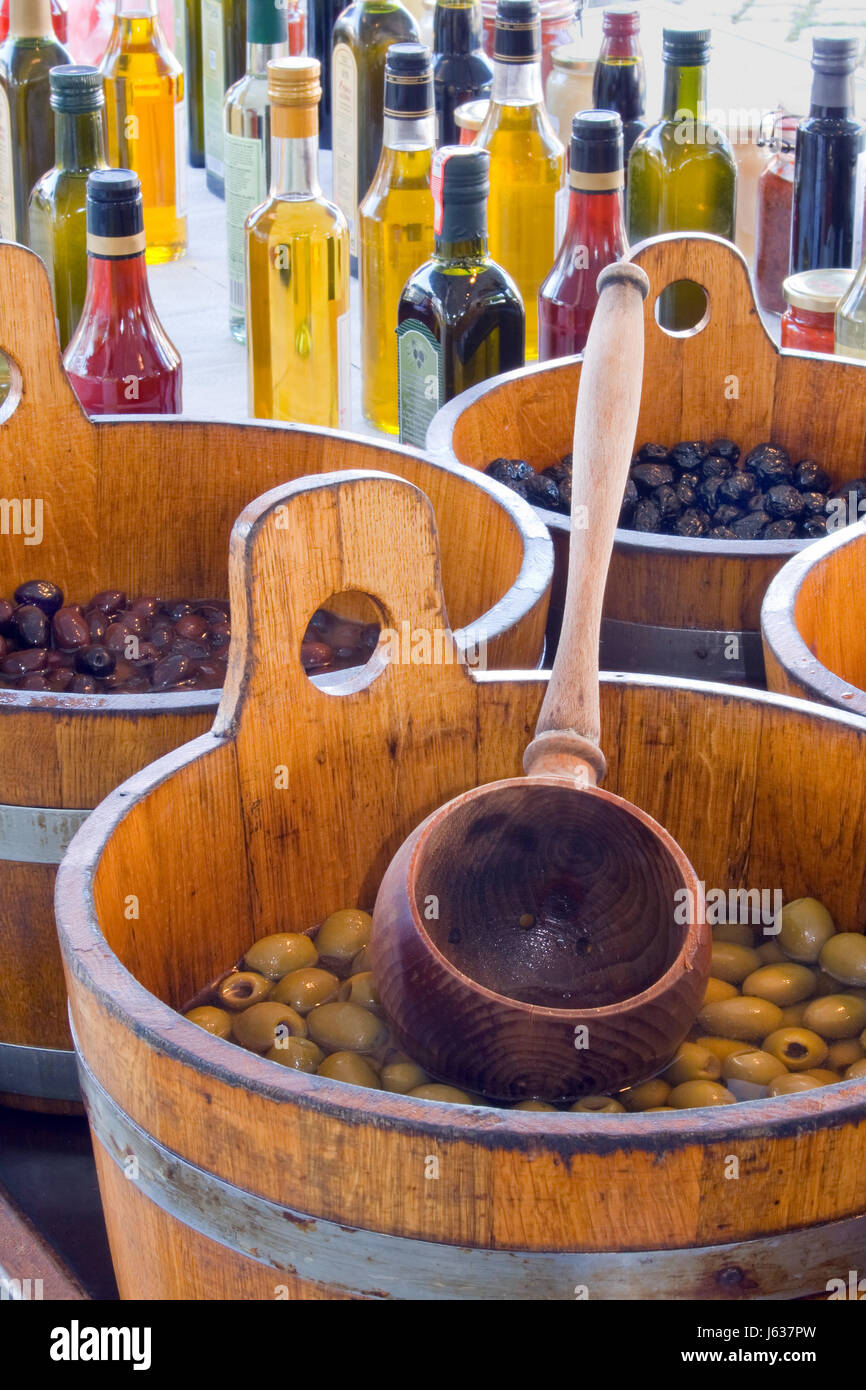 stone fruit olive oil bottles spices olives deposit food aliment market stall Stock Photo