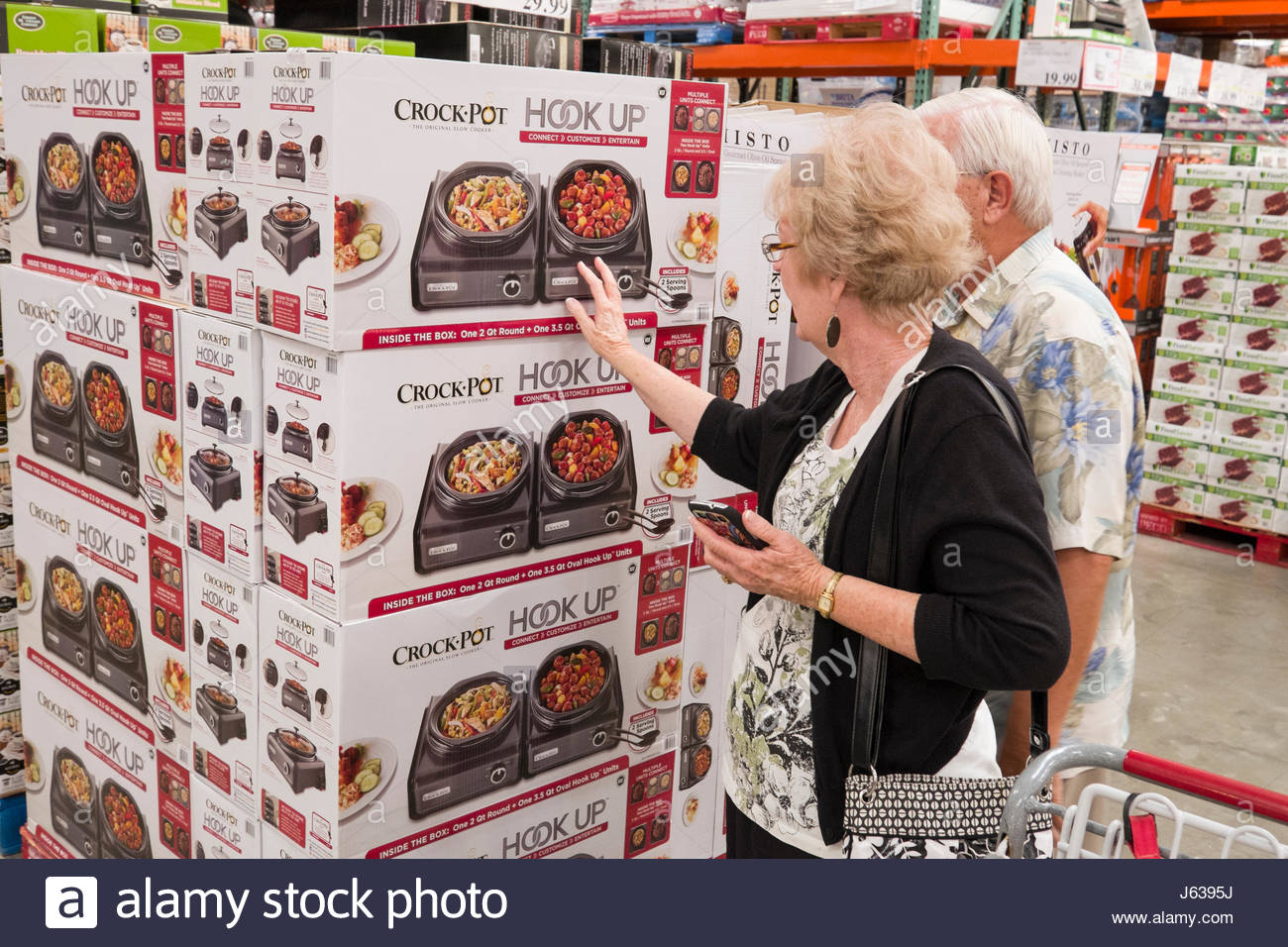 Mature Couple Shopping In Costco Warehouse Supermarket Looking At