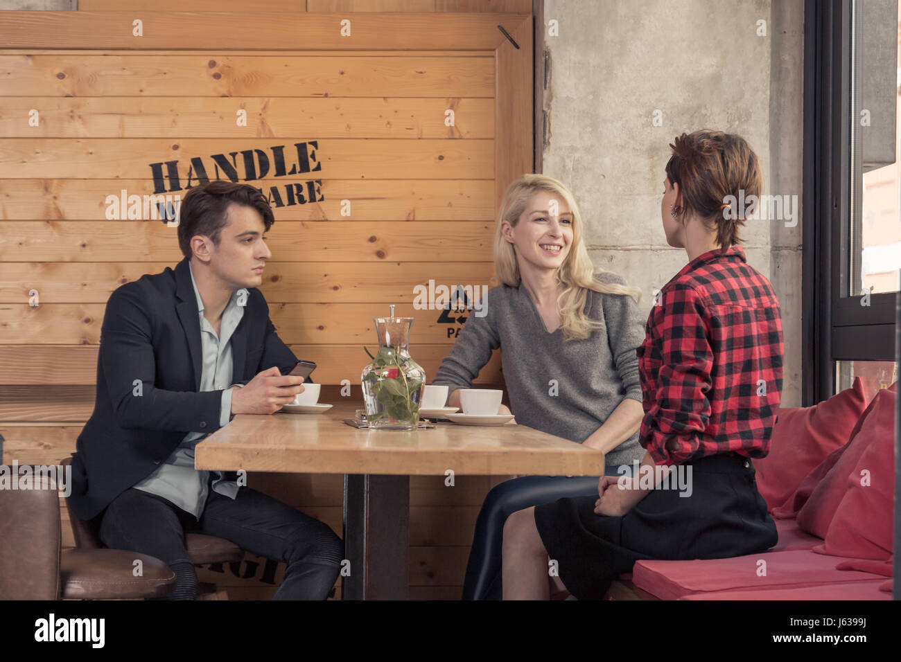 three people walking, small group of people, sitting in coffee shop