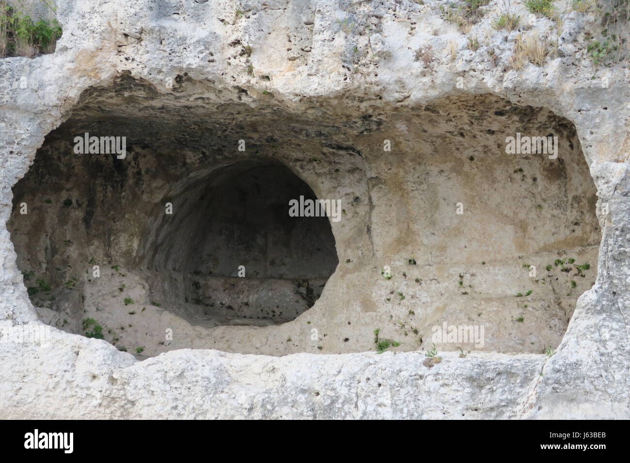 A niche cut into the rock above the ancient Greek theatre at Temenites ...