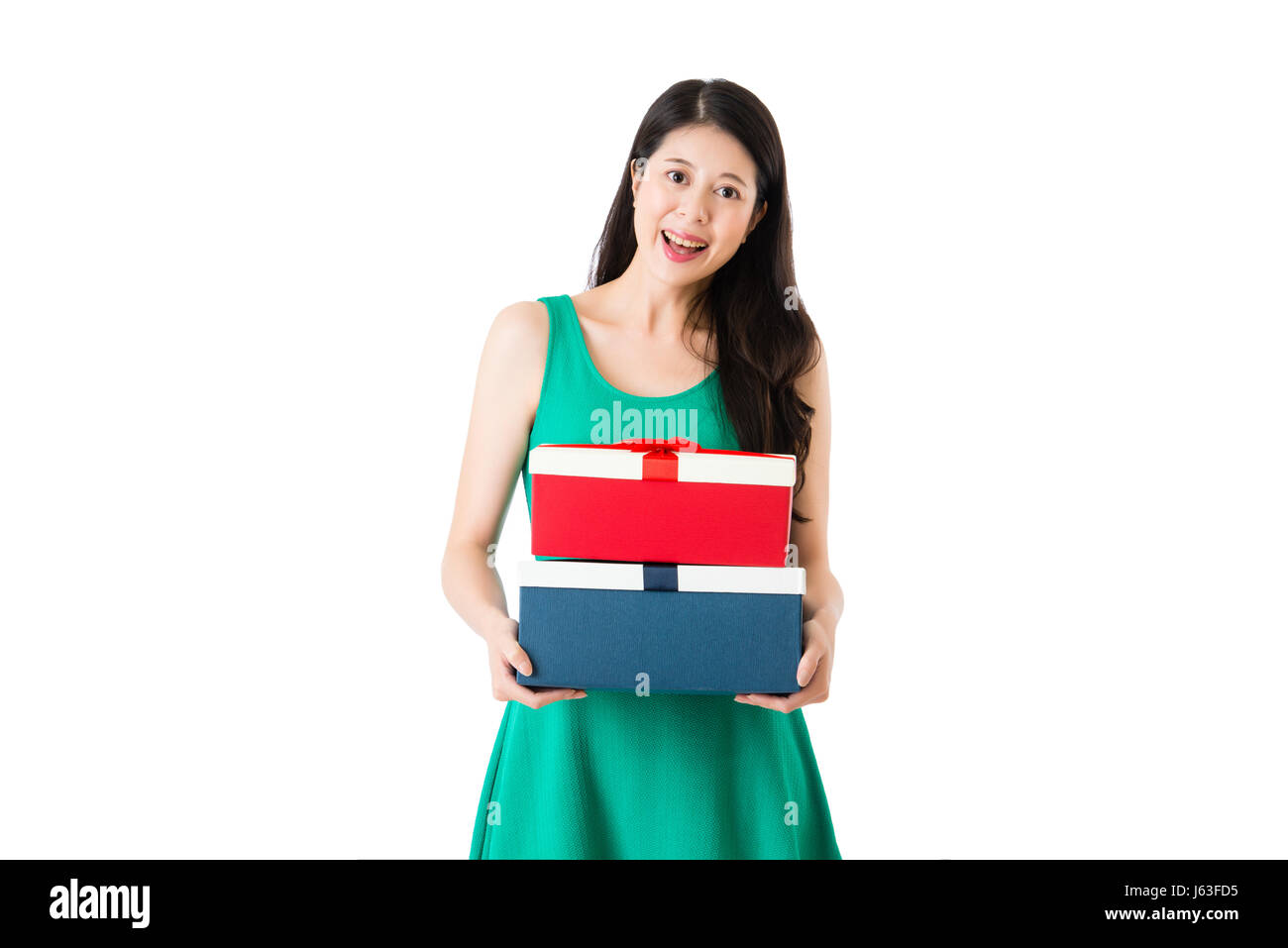 smiling young girl hold red and blue boxes with beautiful green dress in the special day isolated on white wall background with copyspace. Stock Photo