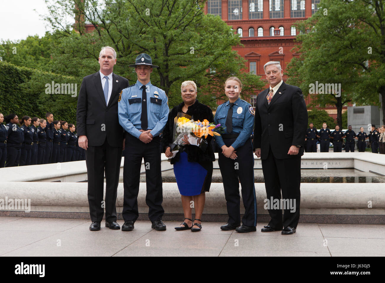 Prince Georges County Police officers and family of fallen officers pose for a group photo in front of the National Law Enforcement Officers Memorial Stock Photo