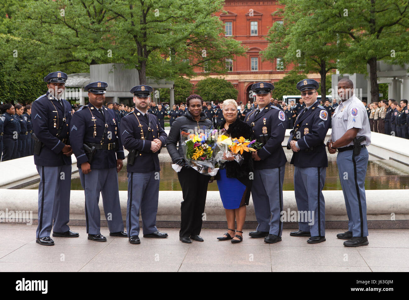 Prince Georges County Police officers and family of fallen officers pose for a group photo in front of the National Law Enforcement Officers Memorial Stock Photo