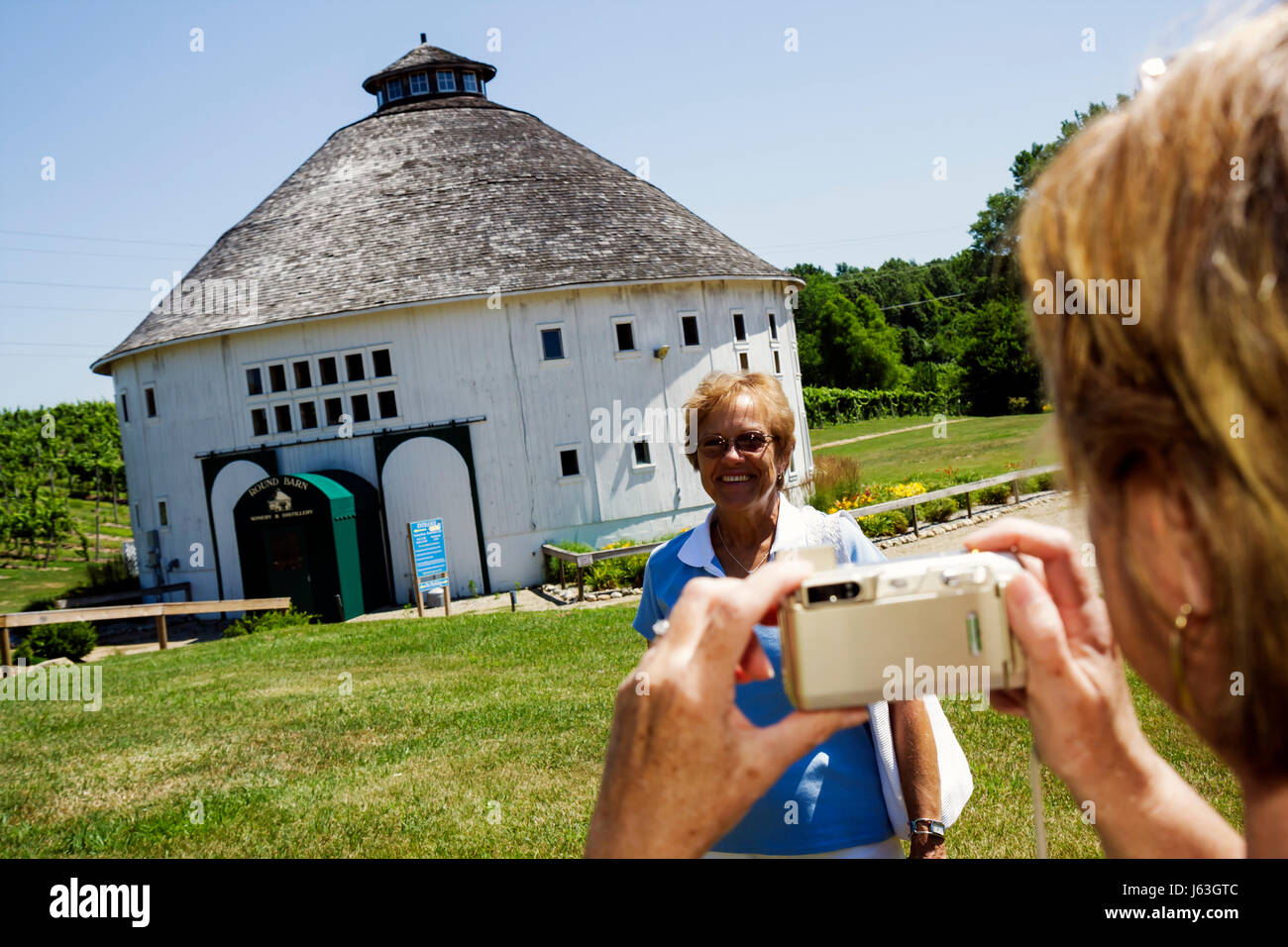Michigan Baroda,The Round Barn Winery Distillery & Brewery,woman female women,restored Amish barn,building,take photo,camera,digital,MI080715036 Stock Photo
