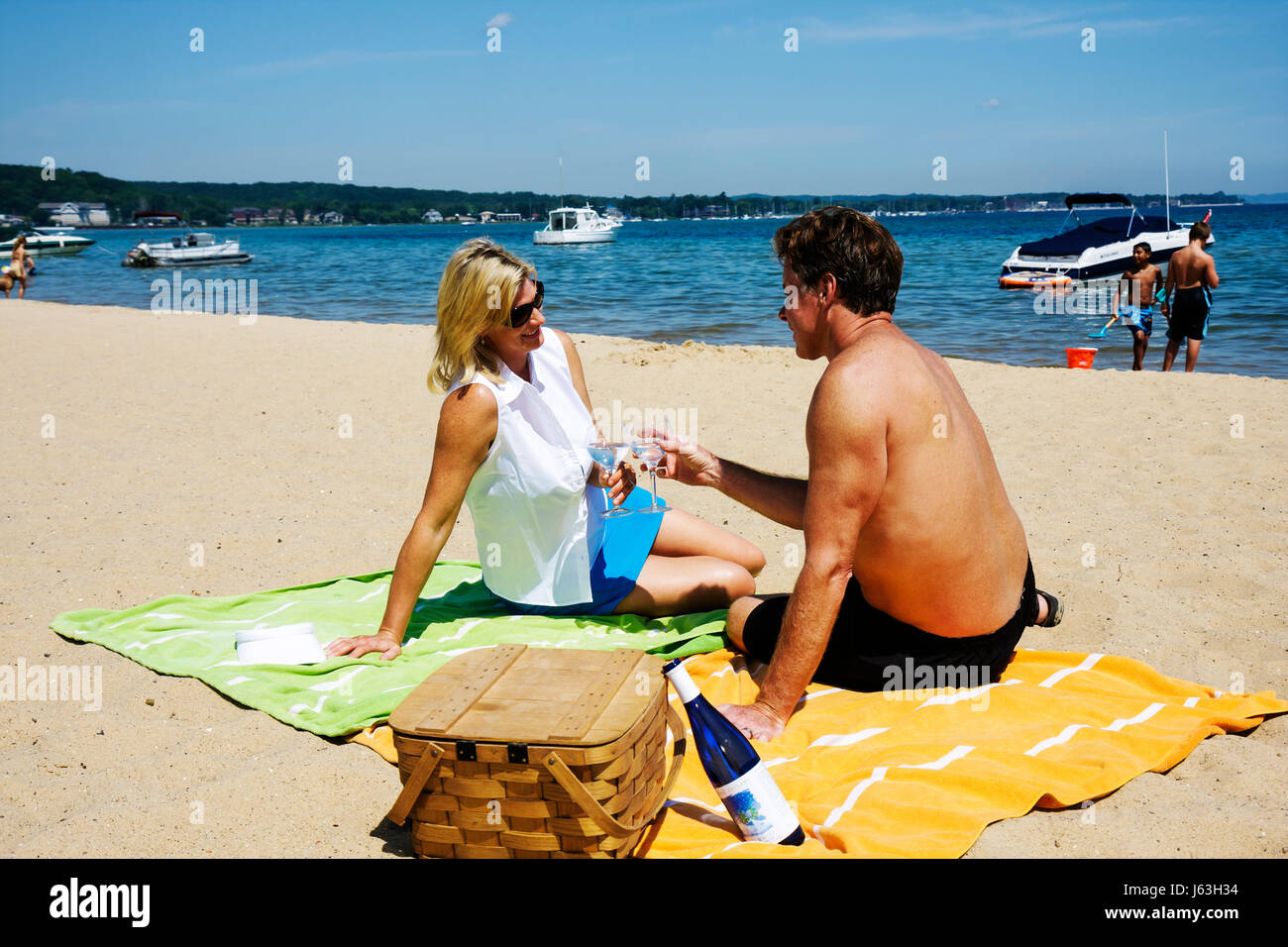 Traverse City Michigan,West Arm Grand Traverse Bay water,Clinch Park,public,beach beaches,sand,picnic,blonde woman,adult adults man men male,couple,ro Stock Photo