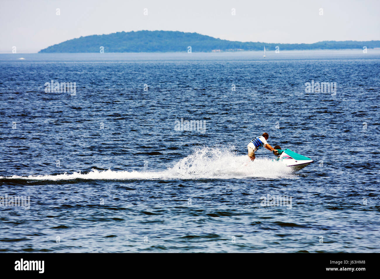 Michigan Traverse City,West Arm Grand Traverse Bay,Clinch Park,man men male,jet ski,water sport,flotation,wake,personal watercraft,outdoor recreation, Stock Photo