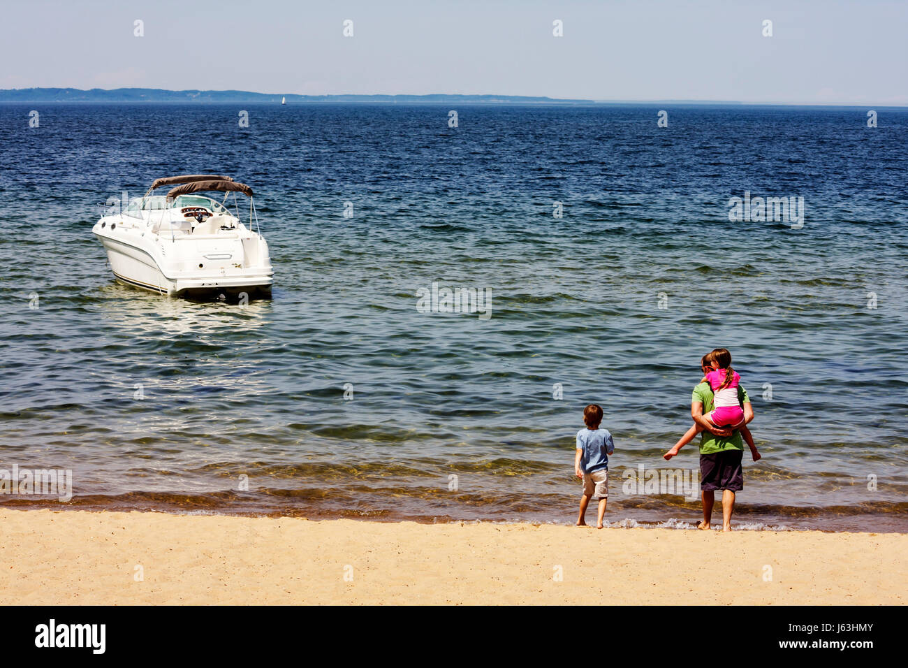 Traverse City Michigan,West Arm Grand Traverse Bay water,Clinch Park,adult adults man men male,boy boys,kid kids child children youngster youngsters y Stock Photo
