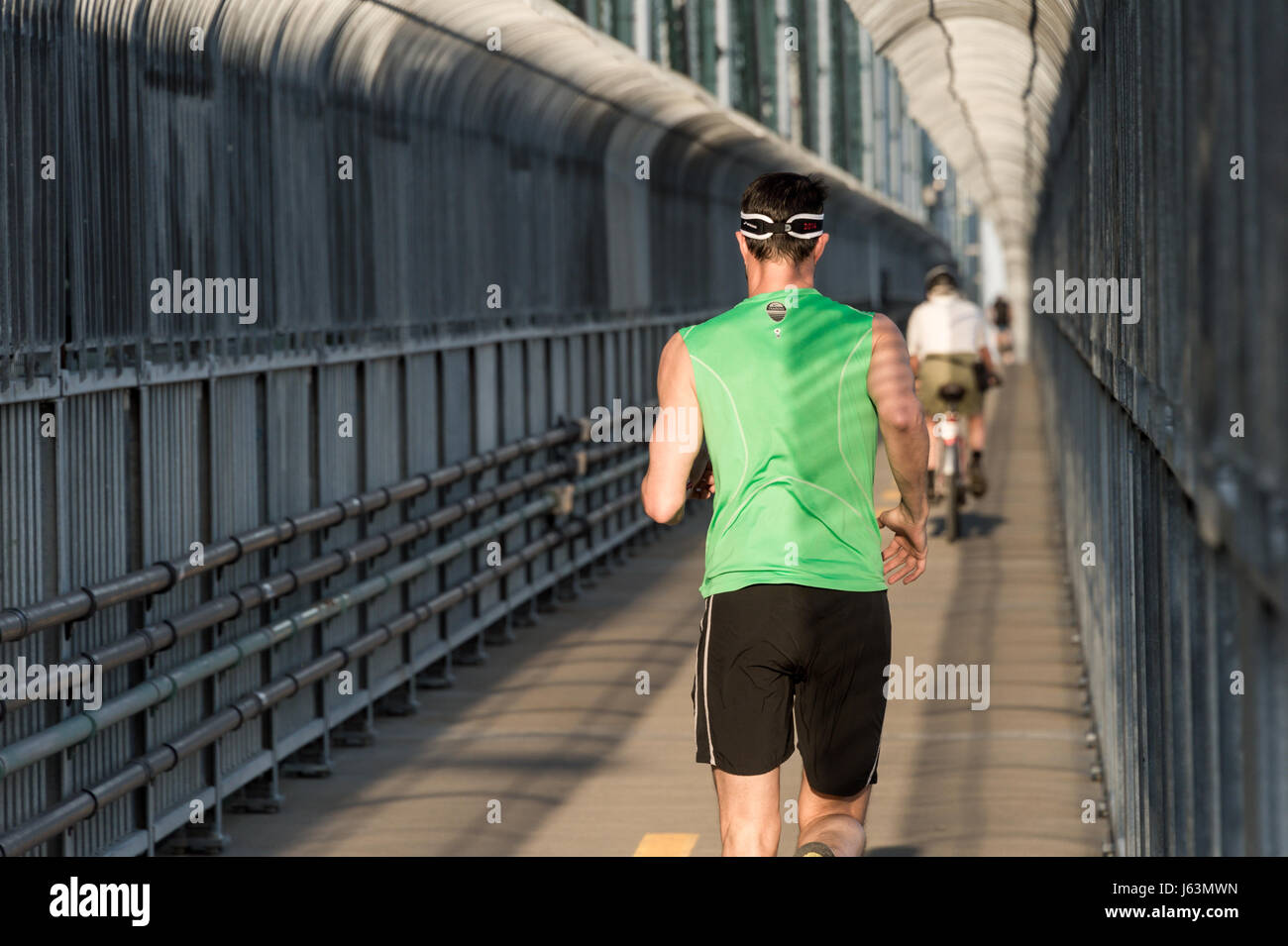 MONTREAL, CA - 18 May 2017: Runner and Cyclist on Jacques-Cartier Bridge's multipurpose path Stock Photo