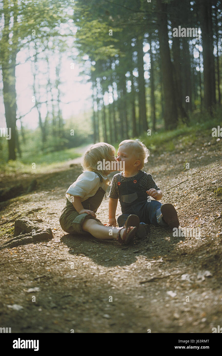 jeans trousers jean trousers sister brother brethren young younger blond girl Stock Photo