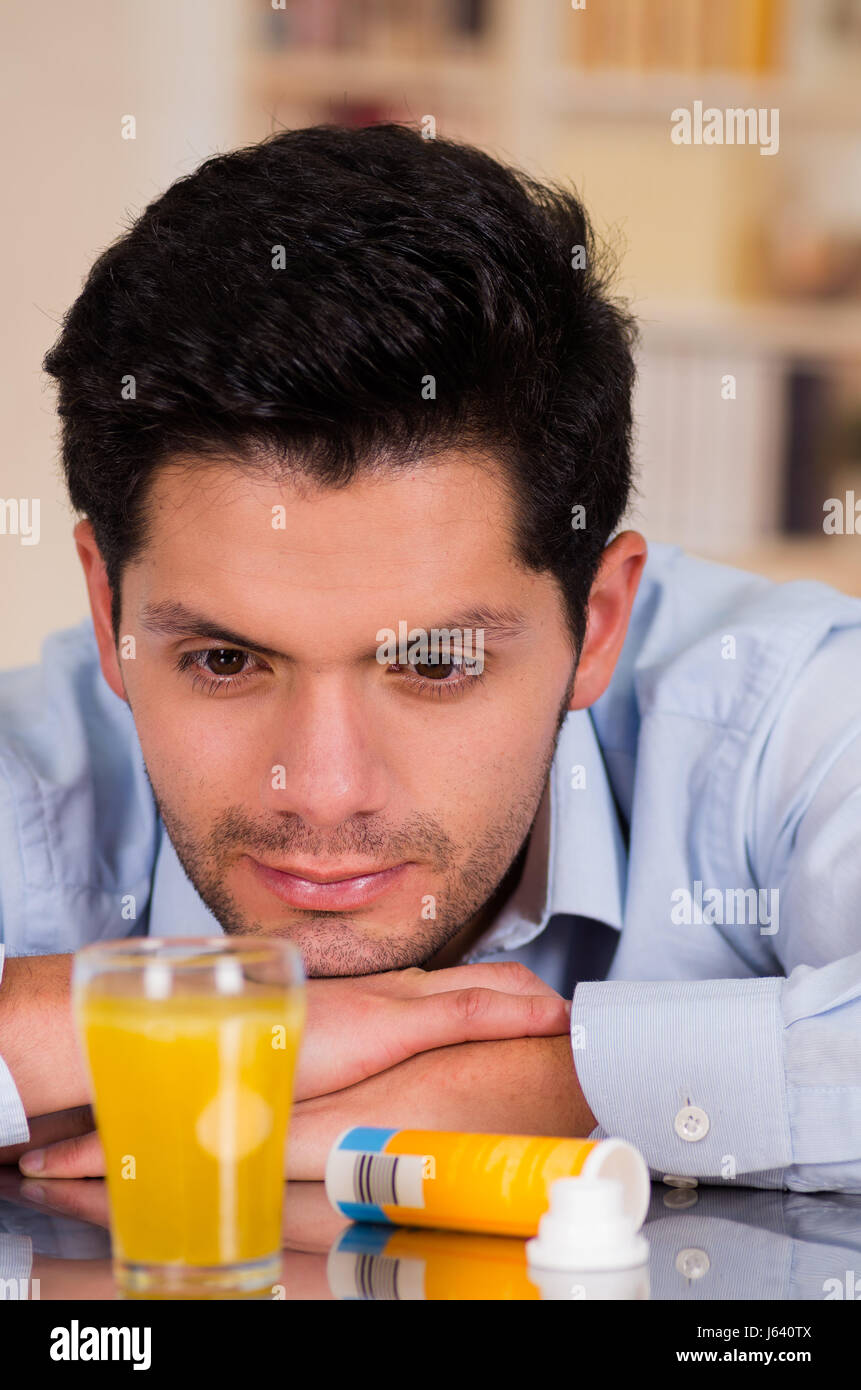 Handsome man watching the effervescent tablet in glass of water Stock Photo