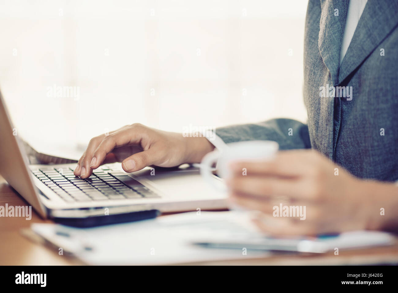 Woman hands typing in a laptop in office Stock Photo