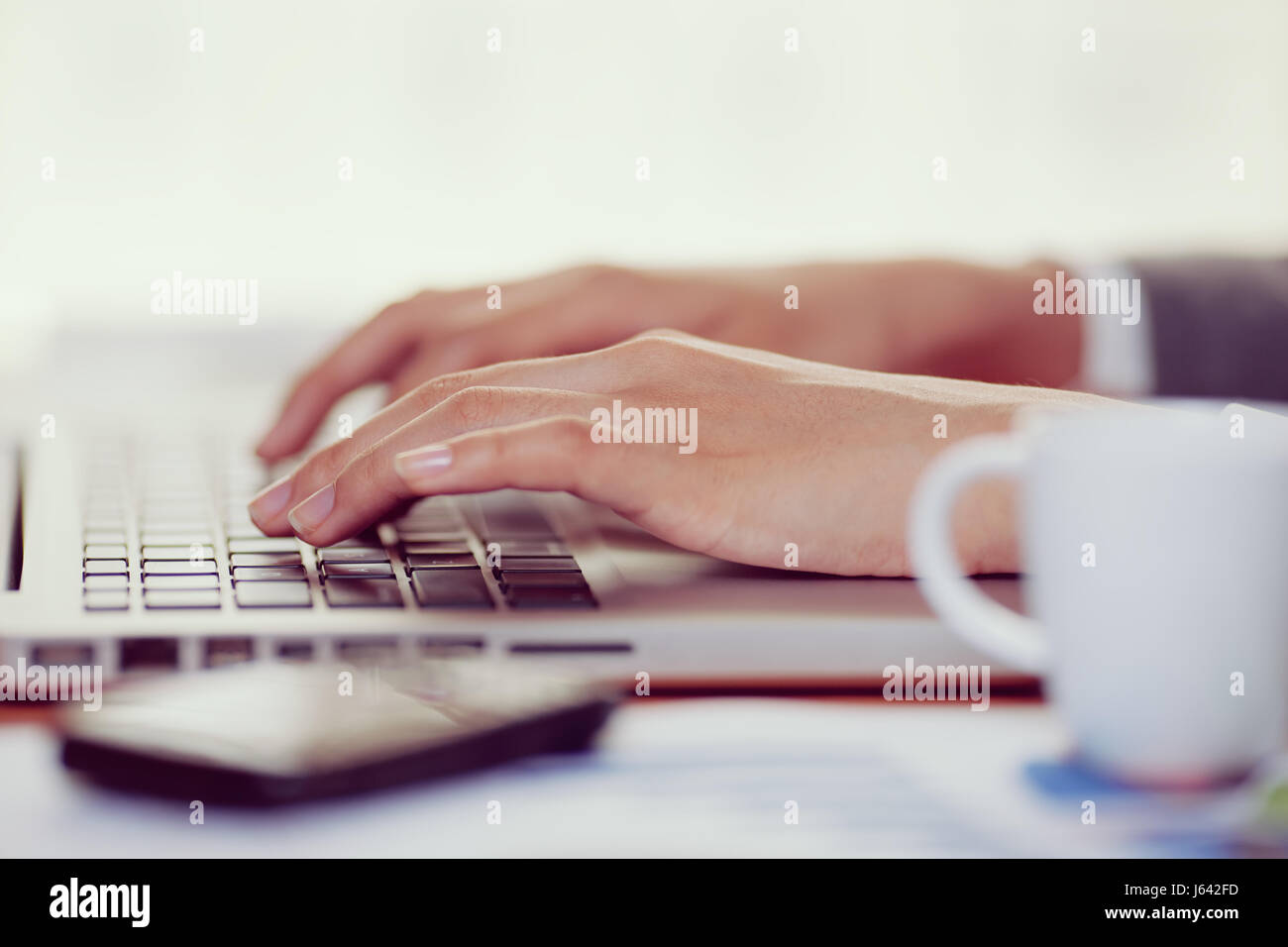 Woman hand typing on her laptop in office Stock Photo