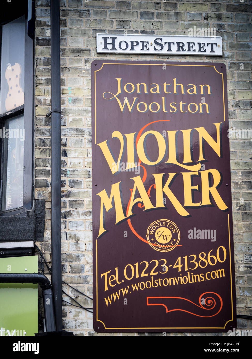 Signs outside the workshop of Jonathan Woolston, Violin Maker, in Mill Road, Cambridge, UK. Stock Photo