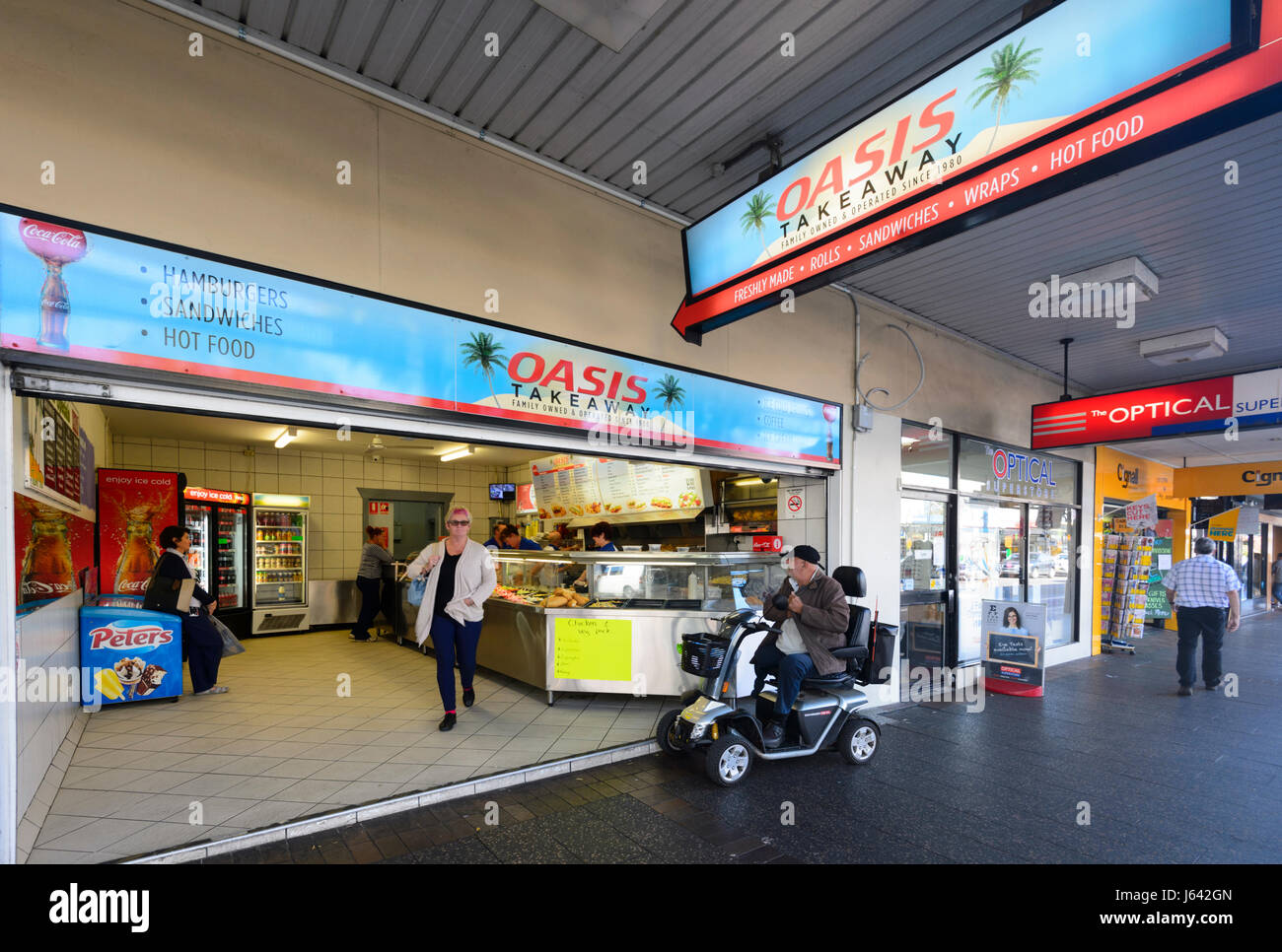 Take-away Shop with an elderly man on a mobility scooter queuing up, Nowra, New South Wales, NSW, Australia Stock Photo