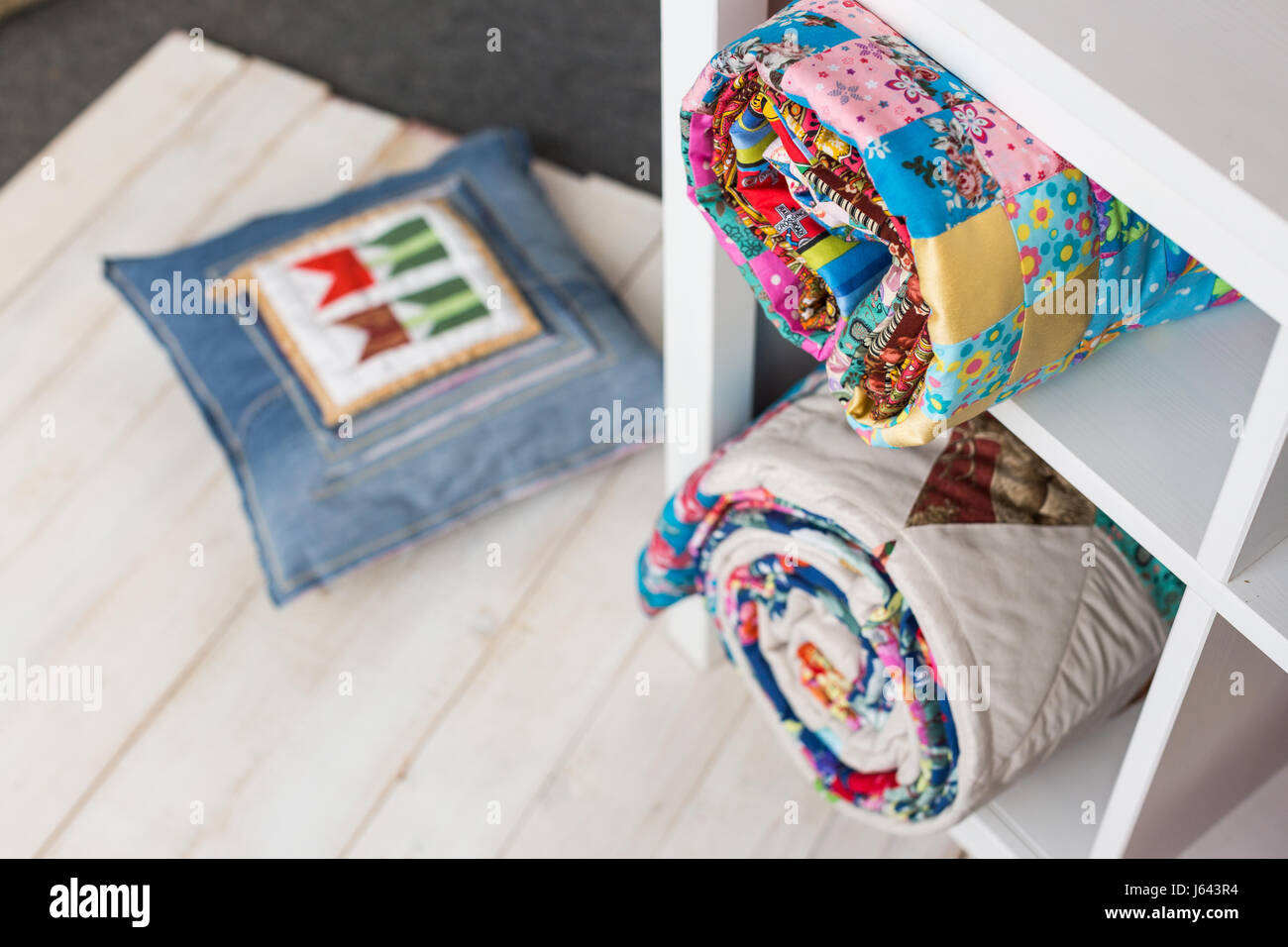 patchwork, sewing and fashion concept two colorful quilted bedspreads