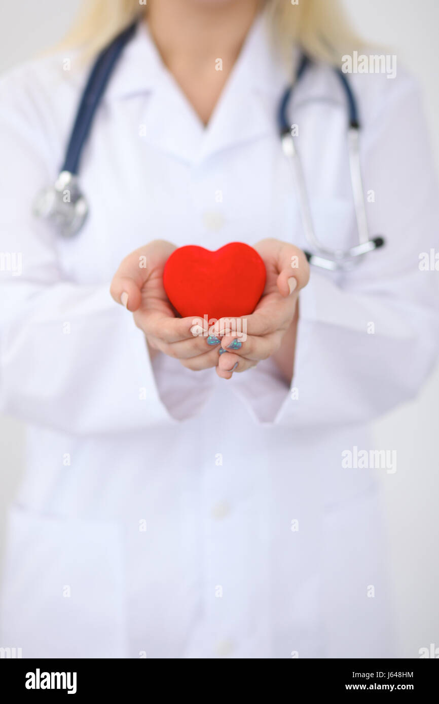 Female doctor with stethoscope holding heart Stock Photo - Alamy