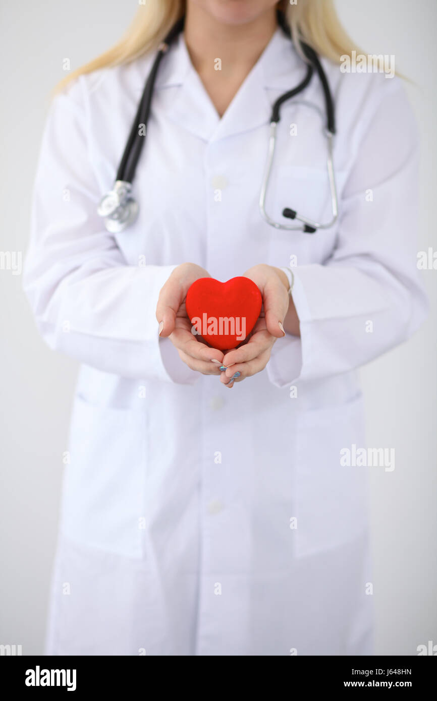 Female doctor with stethoscope holding heart Stock Photo - Alamy