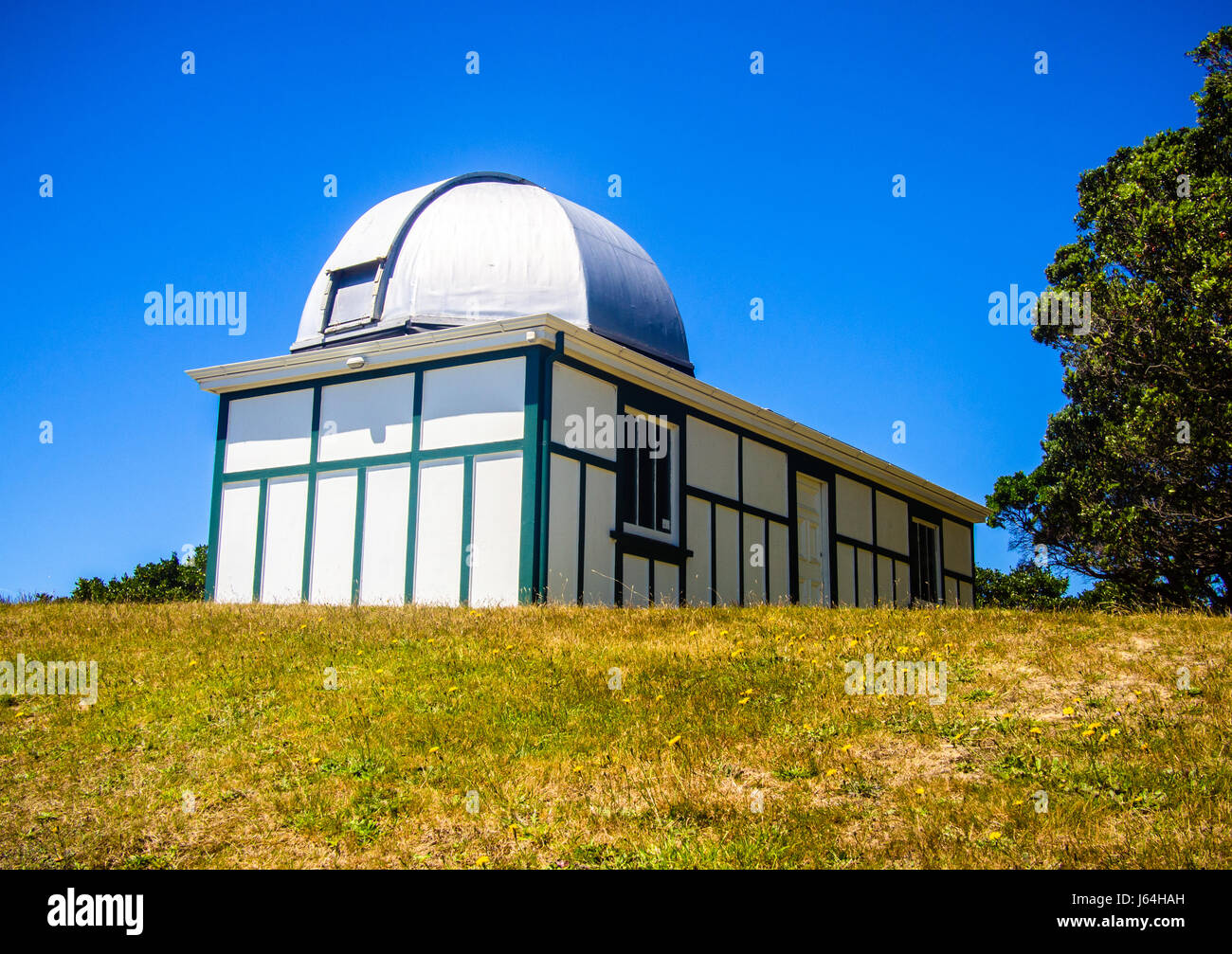 Old Observatory Building On The Top Of A Small Hill Against A Blue Sky Stock Photo
