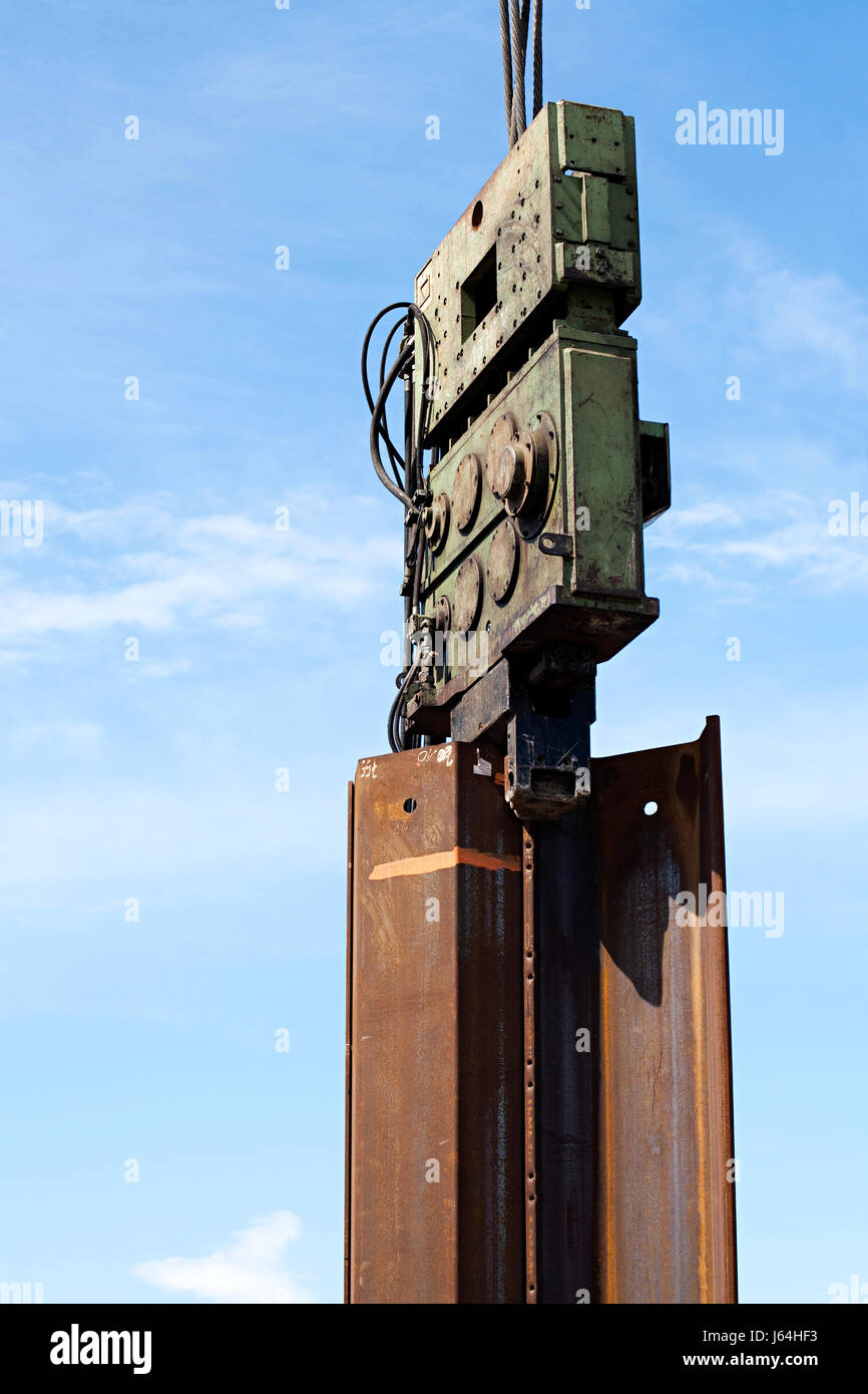 industry industrial steel pile driver construction machine blue closeup