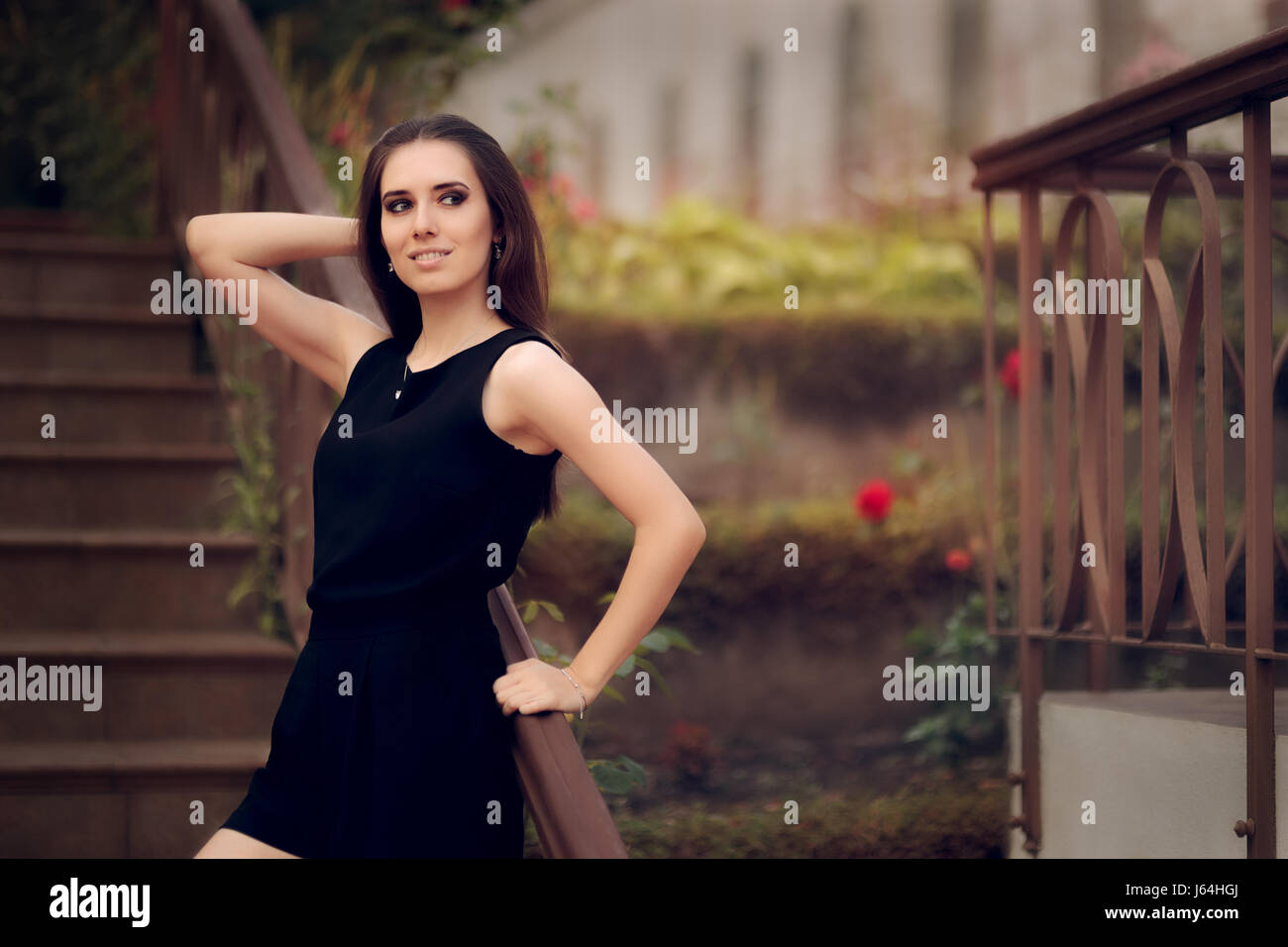 Elegant Woman Wearing Black Dress Standing in a Patio Stock Photo Alamy