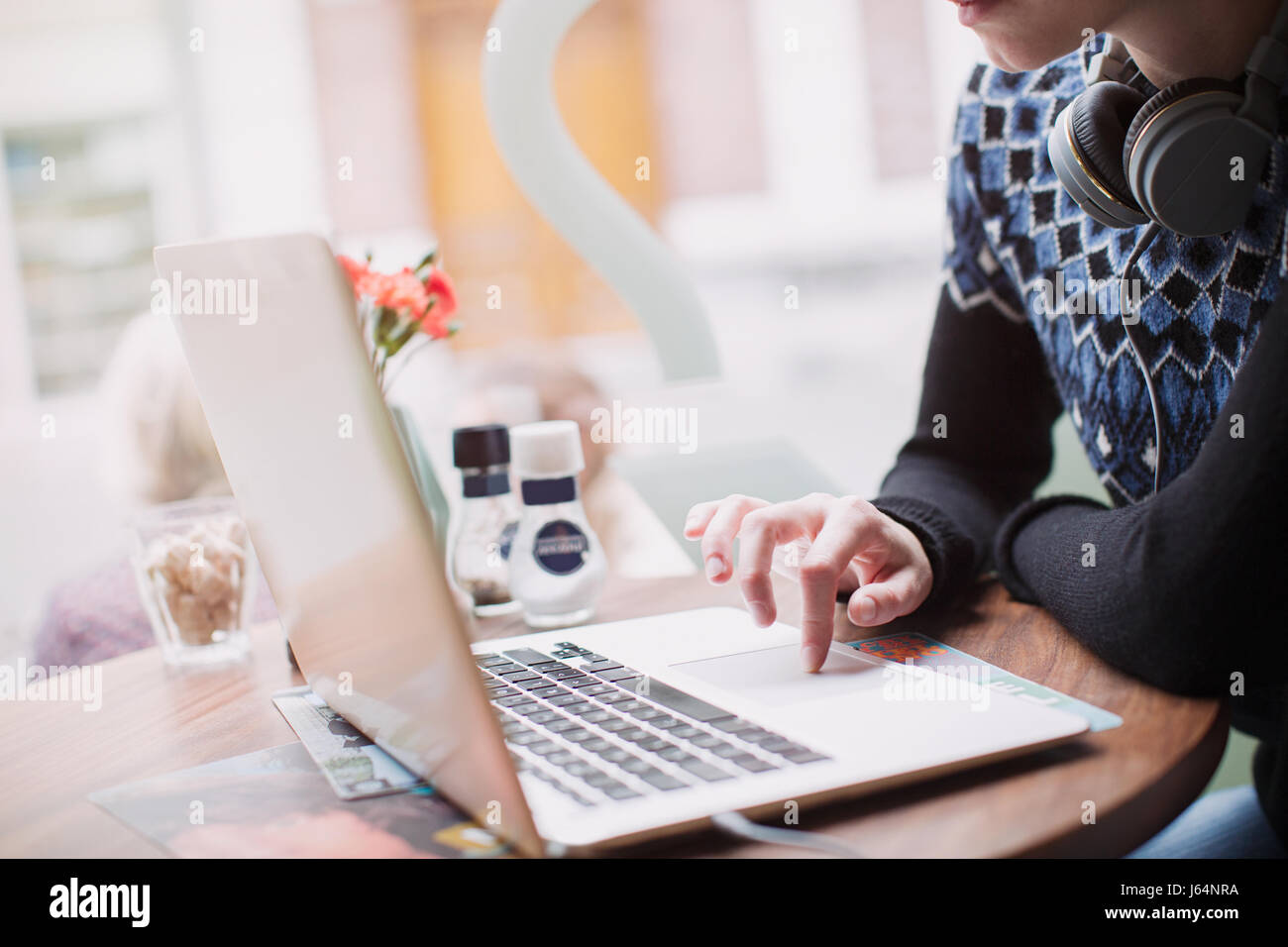 Woman using laptop at cafe window Stock Photo