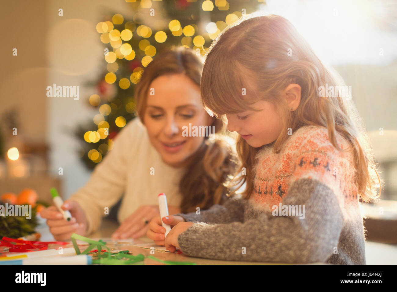 Mother and daughter making Christmas decorations Stock Photo