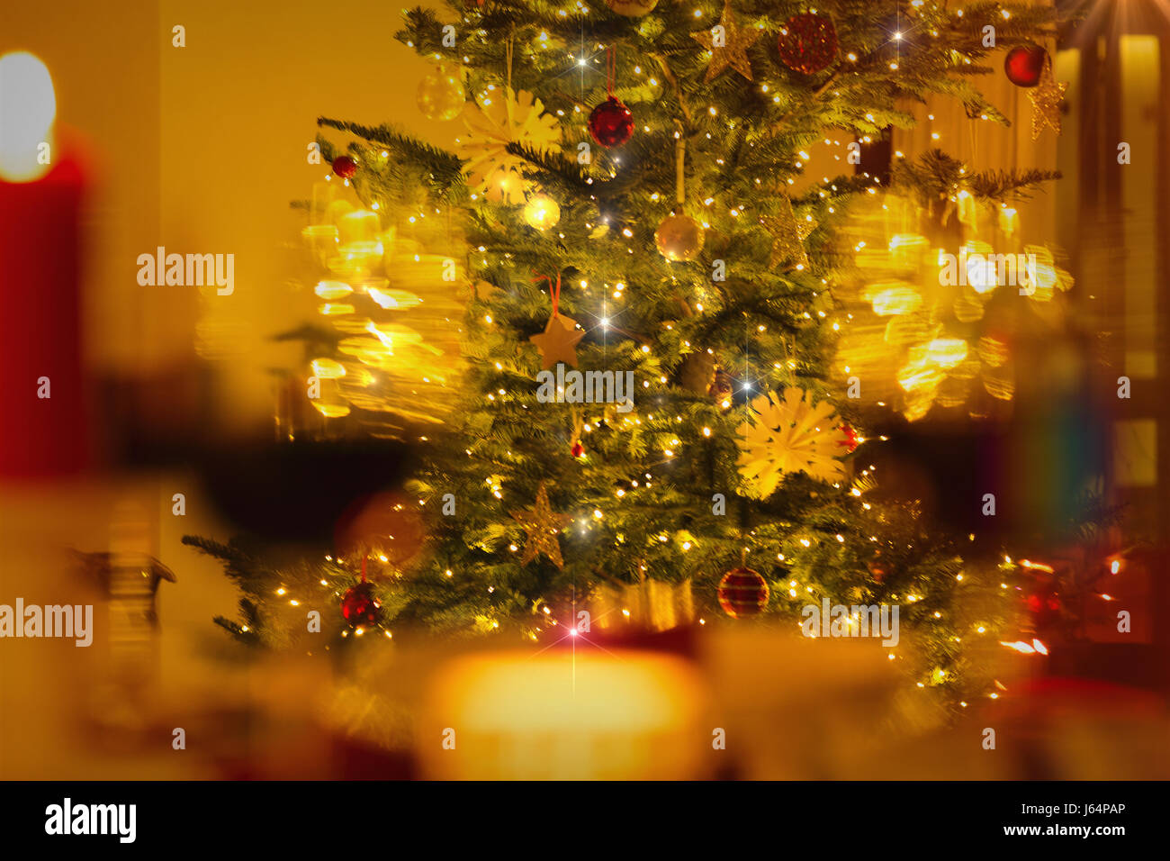 Illuminated Christmas tree with ornaments and string lights Stock Photo