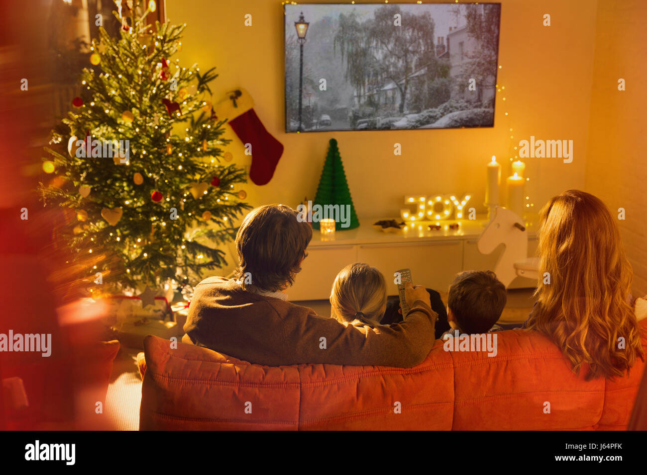 Family watching TV in Christmas living room Stock Photo