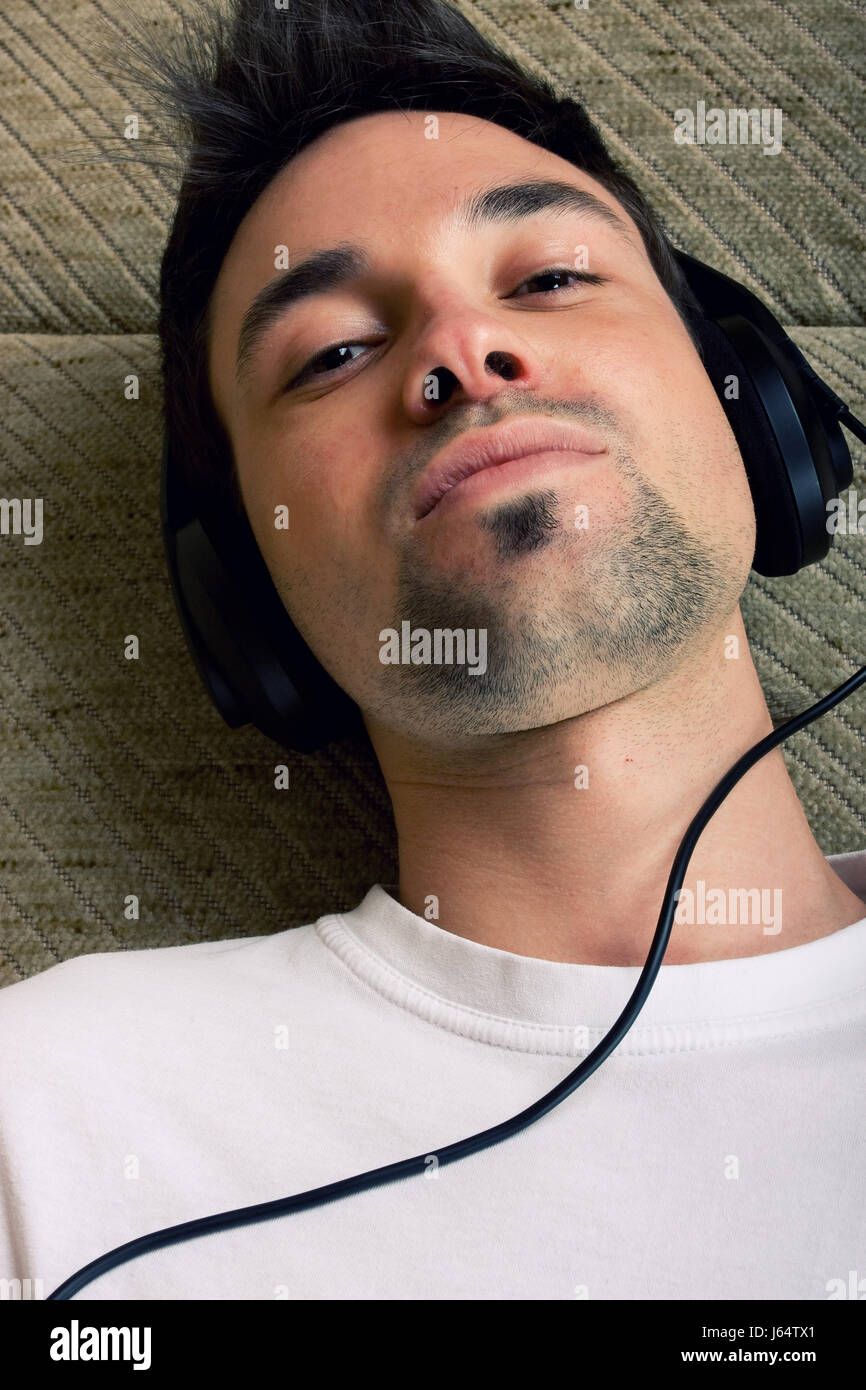 listen music earphones headphones facilitate ease resting relax recover Stock Photo