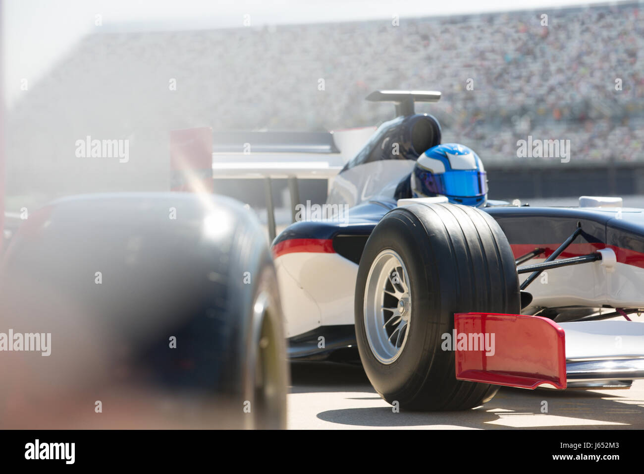 Formula one race car and driver in pit lane Stock Photo