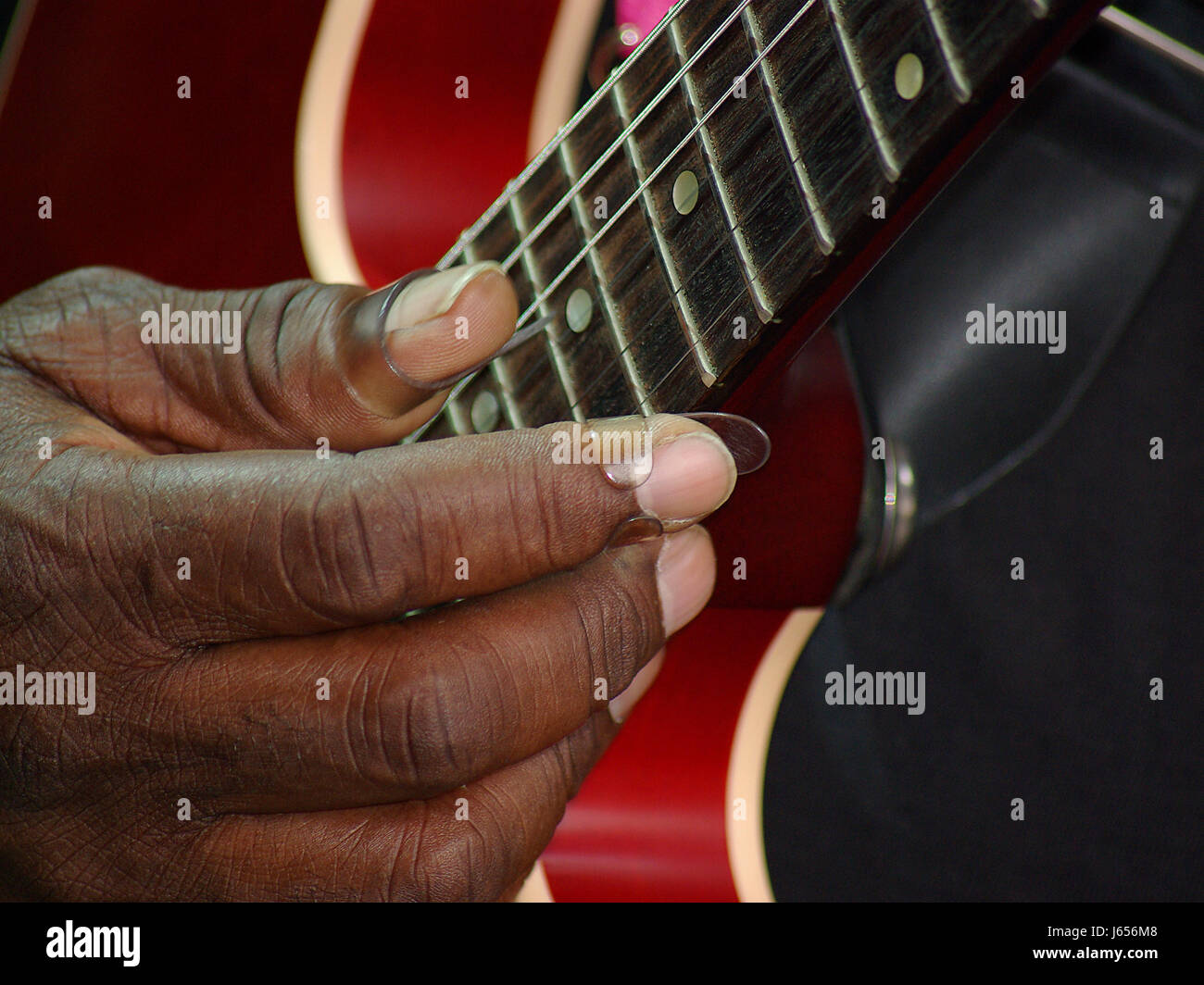 hand music guitar strings red macro close-up macro admission close up view Stock Photo