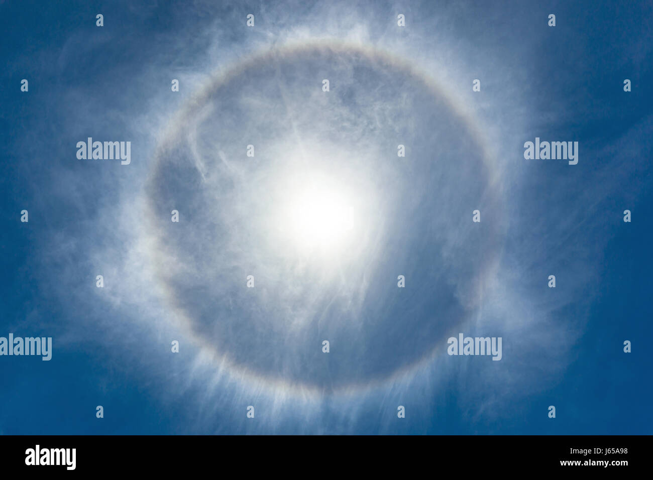 Looking up at a halo around the bright midday sun. Another hot and humid day on a tropical Caribbean island paradise. Stock Photo
