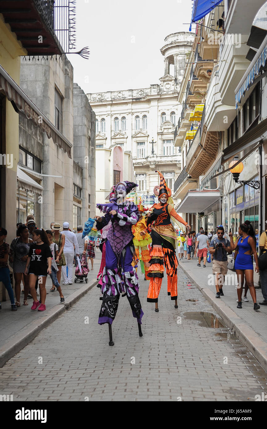 Street performers dancing on stilts on Calle Obispo, or Bishop street, one of the most famous and traveled streets of Havana. Cuba Stock Photo