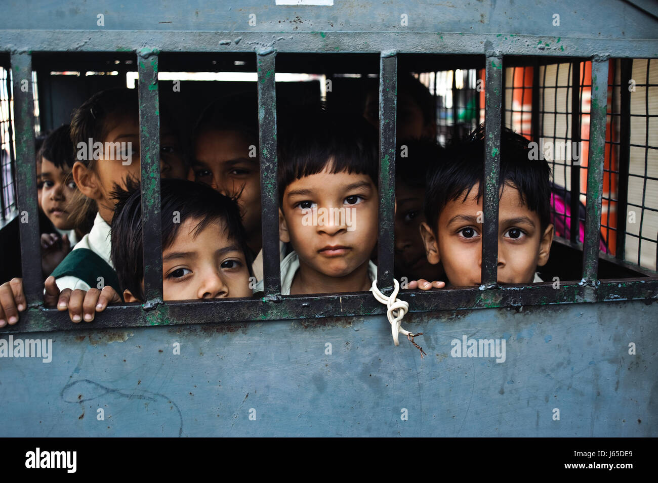 Schoolchildren inside a vehicle taking them to school ( India) Stock Photo