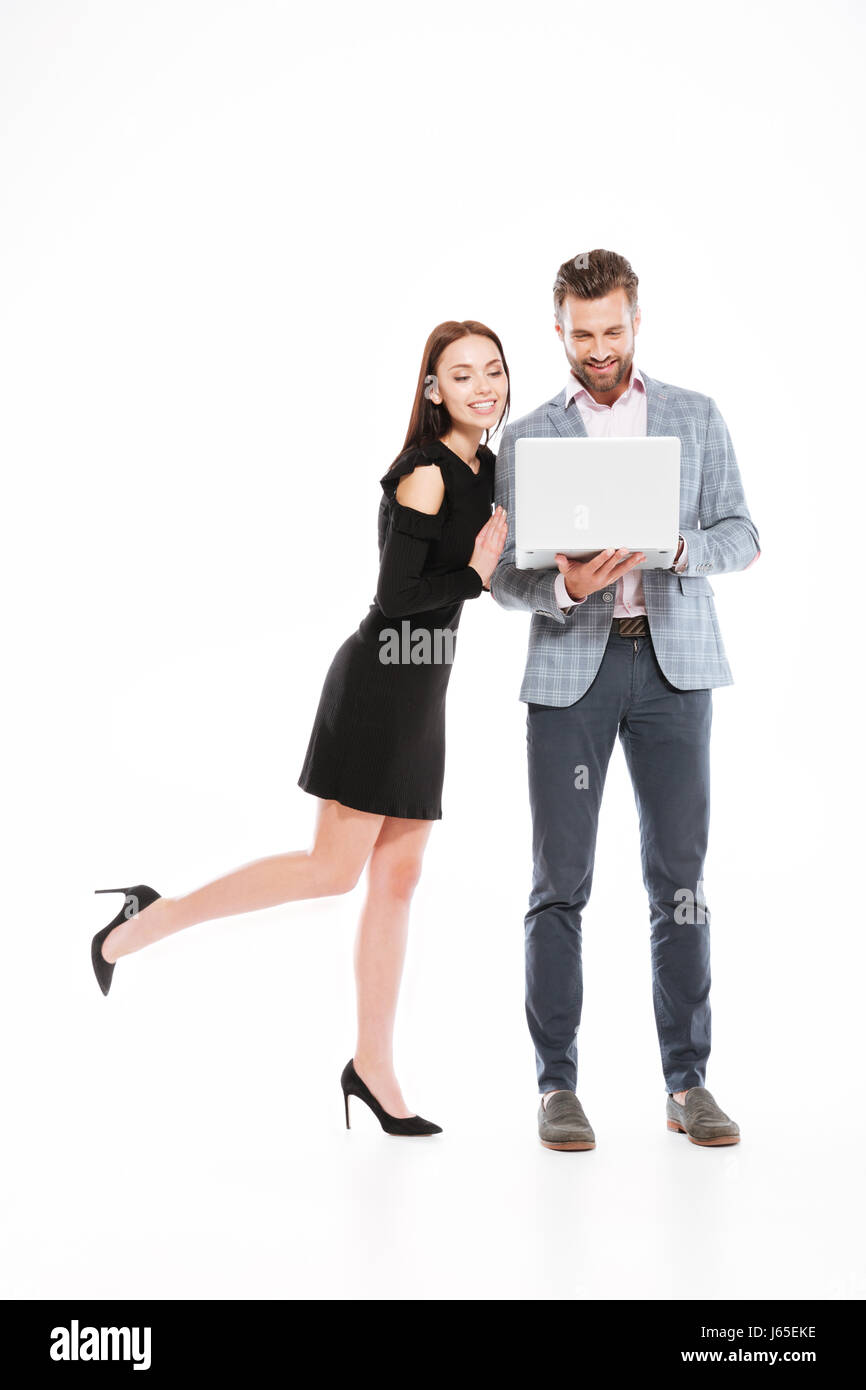 Photo of cheerful young loving couple standing isolated over white ...