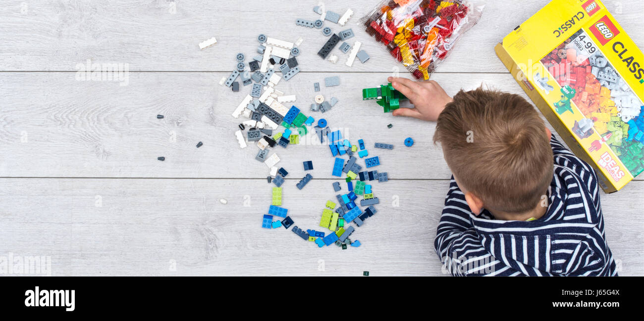 young kid playing with new lego Stock Photo
