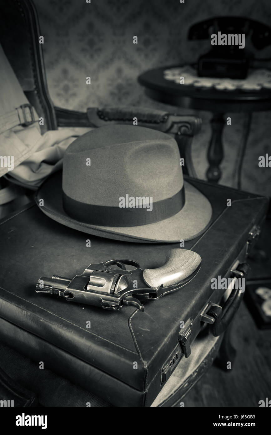 Detective equipment with briefcase, hat and gun, vintage interior on