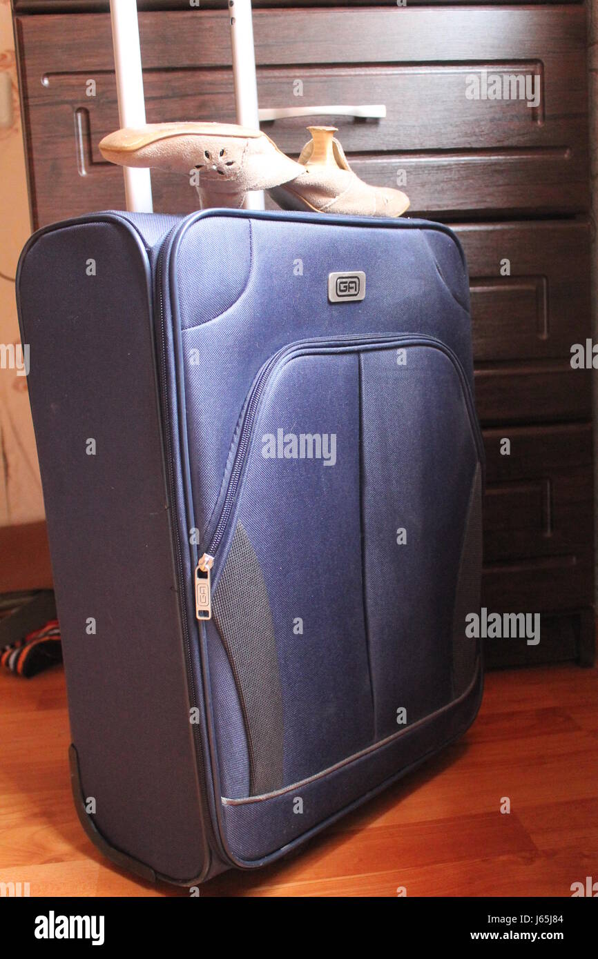 convenient blue suitcase with metal handle prepare to go in trip Stock Photo